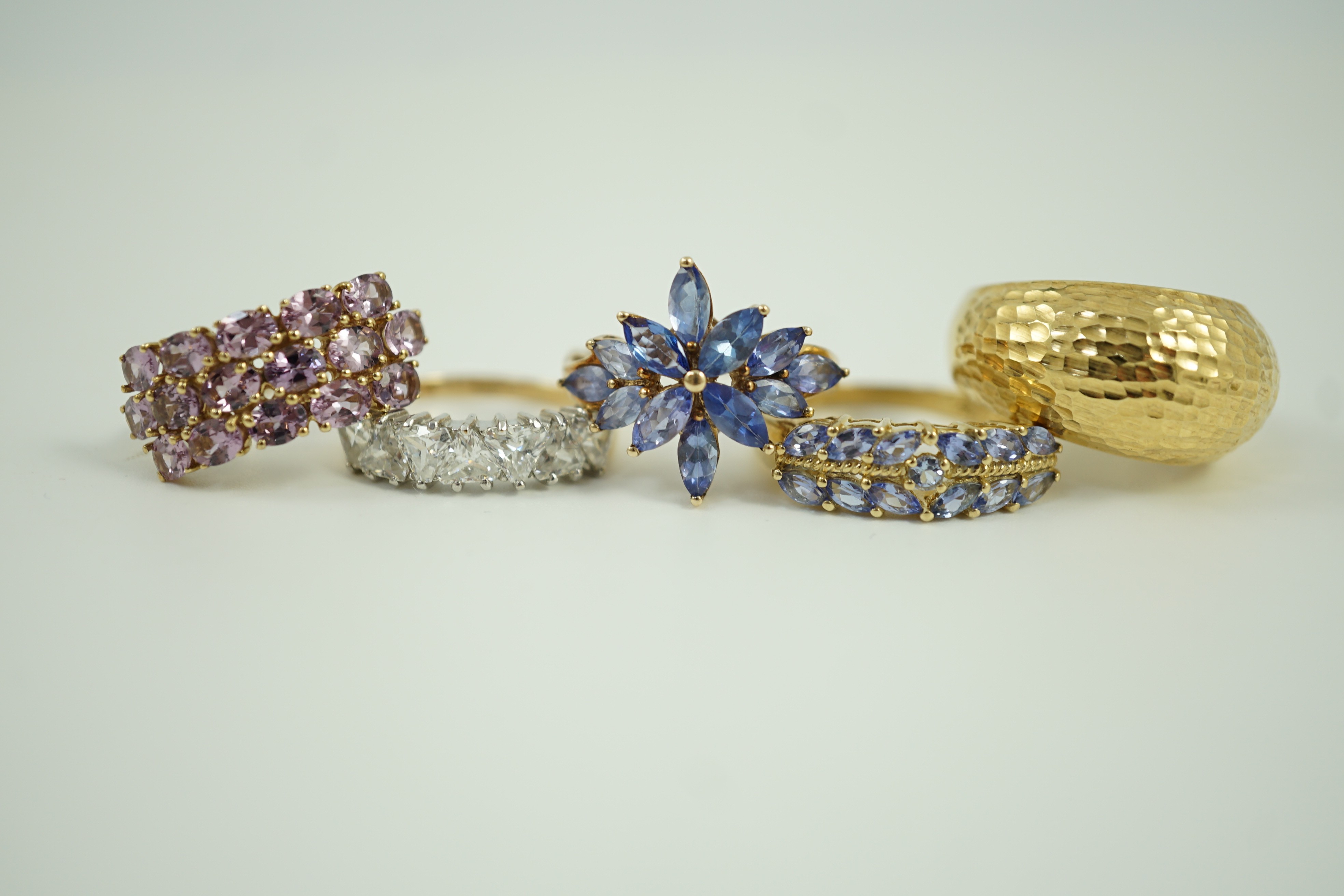 Four assorted modern 9ct gold and gem set rings and an Italian 375 ring, gross weight 14.4 grams.